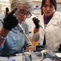 Researcher demonstrating to visitor