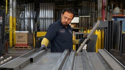 person assembling steel in a factory