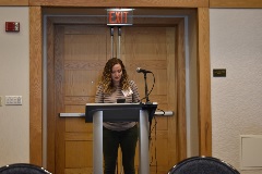 person presenting at a podium