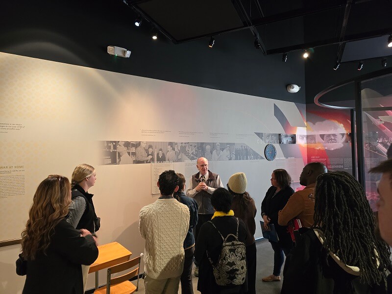 group listening to a presentation in a museum
