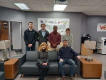 Group of students and faculty sitting and standing at the international chemical workers union council
