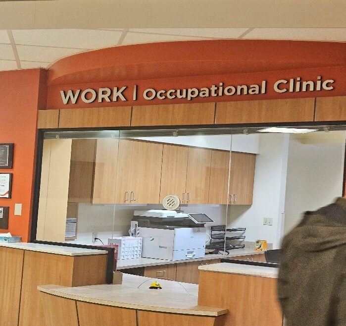 sign at an occupational health clinic reception desk