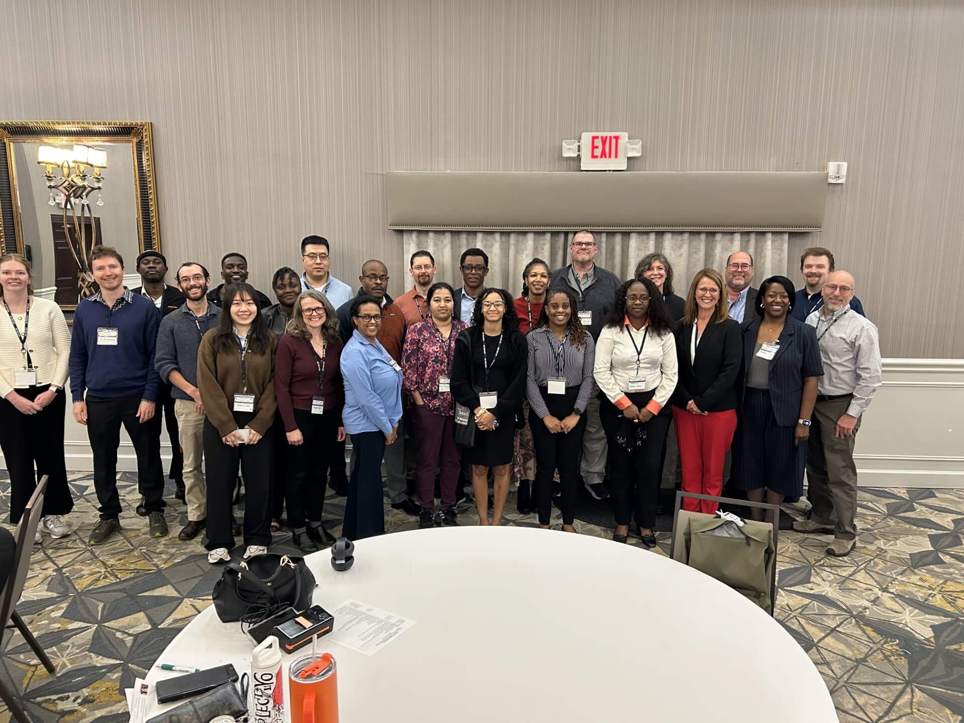 group of people standing together in hotel conference room