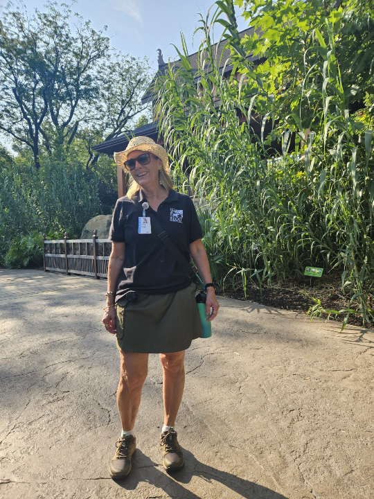 person in zoo uniform standing outside