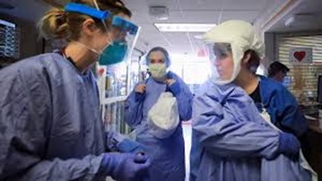 three healthcare workers in scrubs