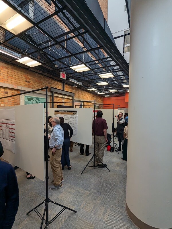 People view posters at a conference