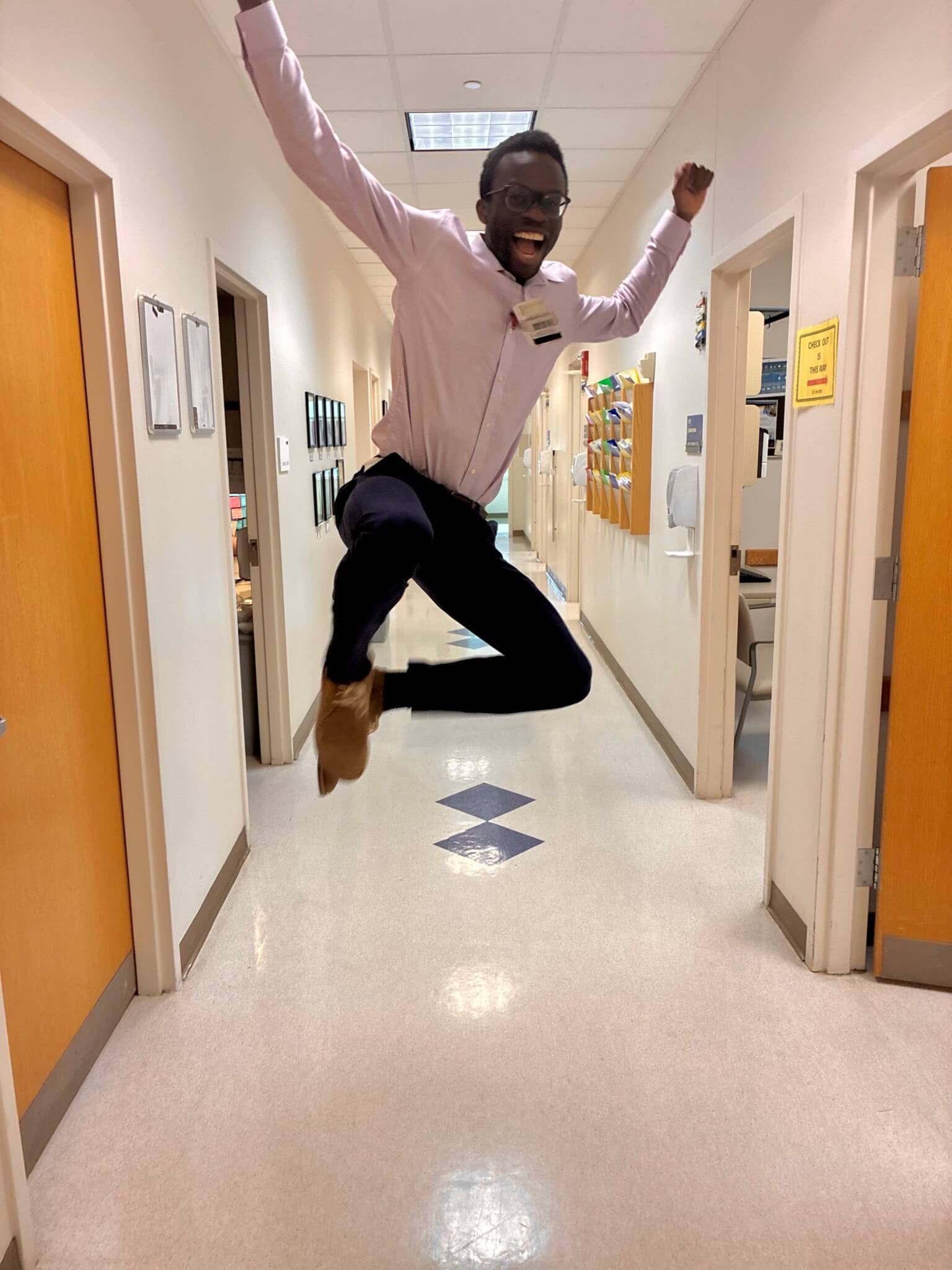 A Med-Peds Resident jumping in the air and clicking his heels in the clinic hallway.