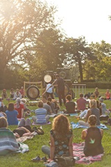 group of people participating in sound immersion at a park