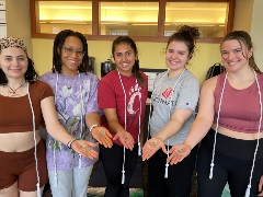 group of yoga students showing hands