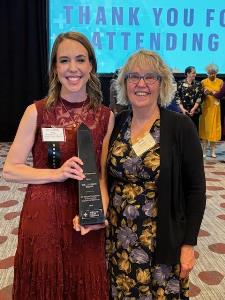 Image of Dr. Wang holding an award