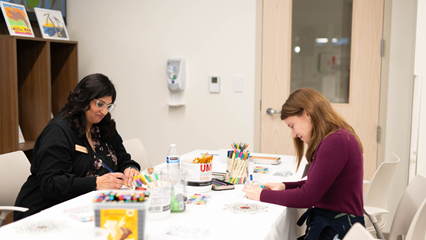 Art therapist and participant participating in art therapy