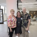 Three people pose for picture with sound immersion in backround