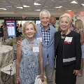 Three people pose for a picture with the suite in the background