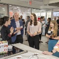 A group of people talking a kitchen