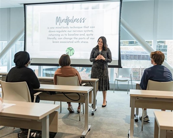 Meriden Mcgraw teaching workplace mindfulness to a group of people