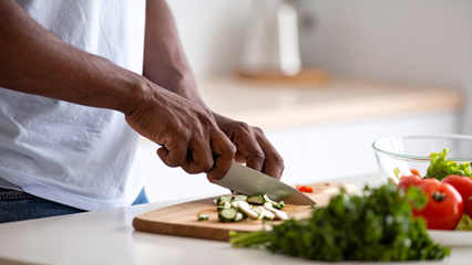 hands chopping vegetables with knife