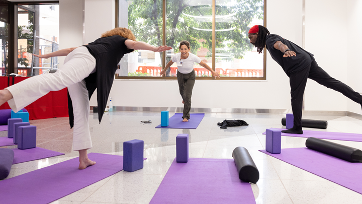 instructor and class participants in a yoga class