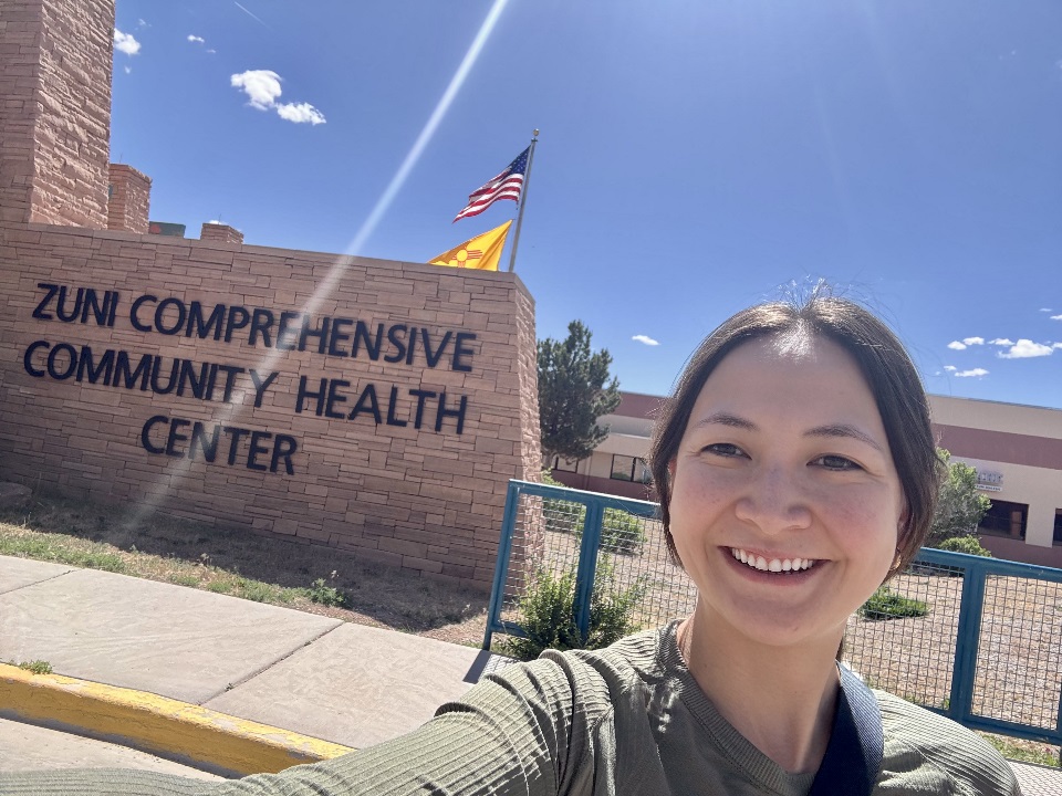 Woman standing in front of sign