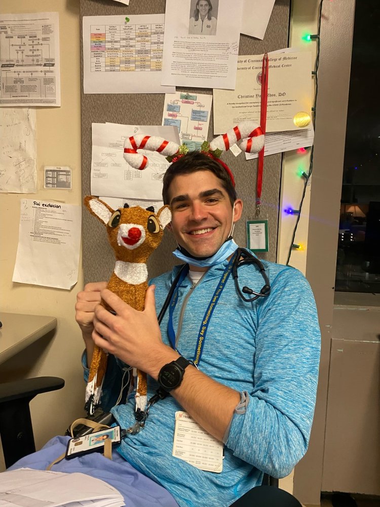 Photograph of a resident physician holding a doll