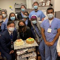 Group around two cakes