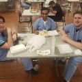 3 men sitting at lunch table